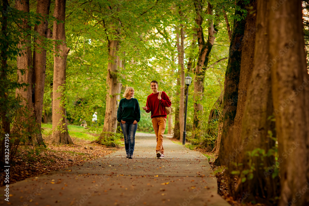 Beautiful woman,blonde,middle-aged,with a big son walking in the Park,a beautiful autumn day Beautiful woman,blonde,middle-aged,with a big son walking in the Park,a beautiful autumn day