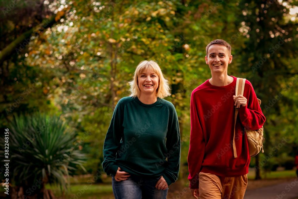 Beautiful woman,blonde,middle-aged,with a big son walking in the Park,a beautiful autumn day Beautiful woman,blonde,middle-aged,with a big son walking in the Park,a beautiful autumn day