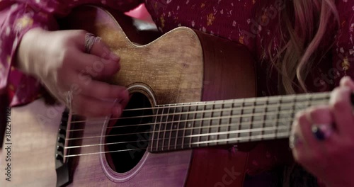 Woman Playing Guitar and Singing.