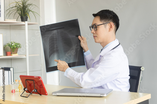 Distance medicine concept. The young doctor is talking to the patient on the laptop.