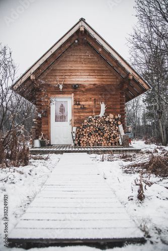A cozy log cabin in the snowy winter landscape