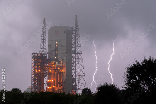 Rocket on the launchpad with lightning photo