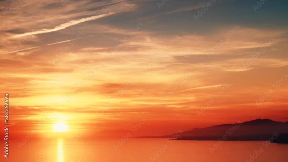 Seascape. Red orange sunset over sea water surface. View from cliffs of Maro Cerro Gordo Natural Park, Malaga province, Costa Del Sol, Andalusia, Spain. Seascape. Red orange sunset over sea water surface. View from cliffs of Maro Cerro Gordo Natural Park, Malaga province, Costa Del Sol, Andalusia, Spain.