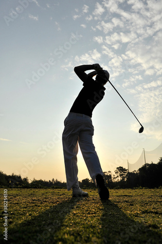 silhouette of a golfer practicing