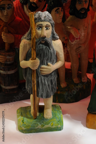 various traditional handmade wooden figurines with souvenirs are presented on the market