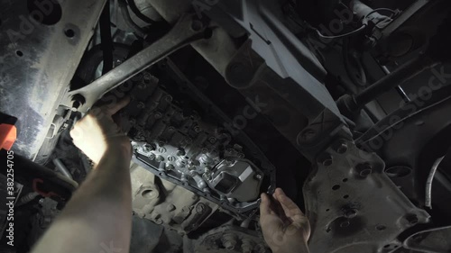 CVT gearbox close up, worker hands changing oil and making maintenance in new modern variator automatic transmission on SUV in Car Service. photo