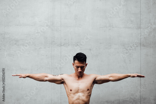 Portrait bare chested man with arms outstretched