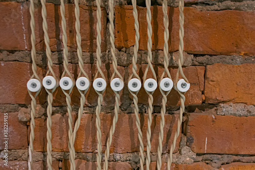 retro old design imitation of electric fuses with electric wires on a red brick wall background 
