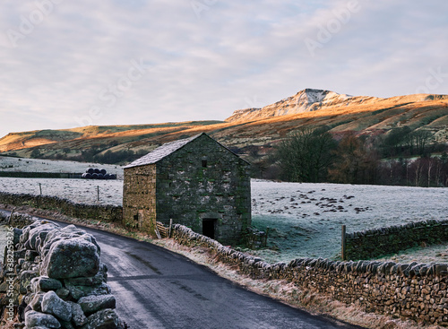 Frost and sunlight over Wild Boar Fell at sunrise. Mallerstang, Cumbria, UK. photo