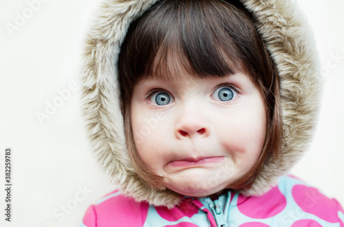 Little girl with a surprised look on her face photo