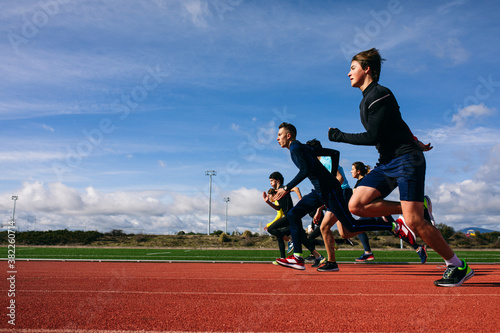 Slika na platnu Teenagers running race on stadium