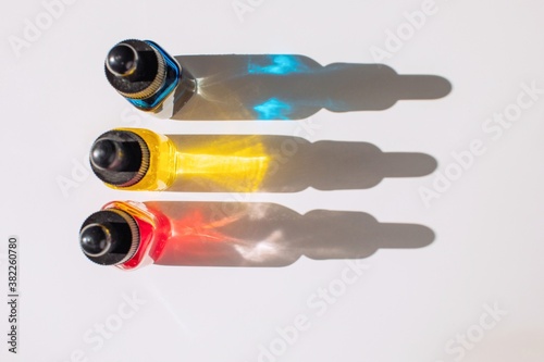 Small bottles with colorful liquids photo