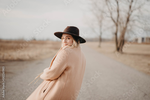 A young blonde woman in her twenties on a rooftop at sunset photo