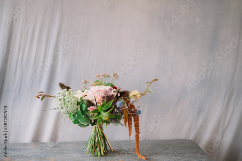Flower bouquet against grey cloth background with copy space