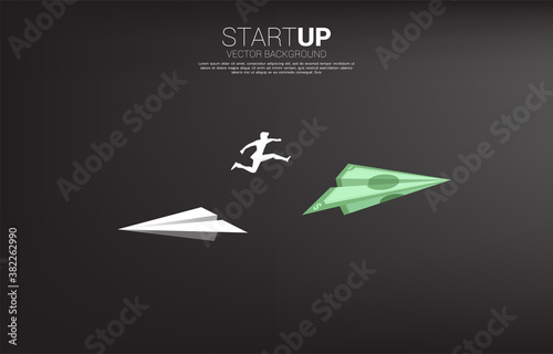 silhouette of businessman jump from white origami paper airplane to bank note money for change direction. Business Concept of changing business direction.Company vision mission.