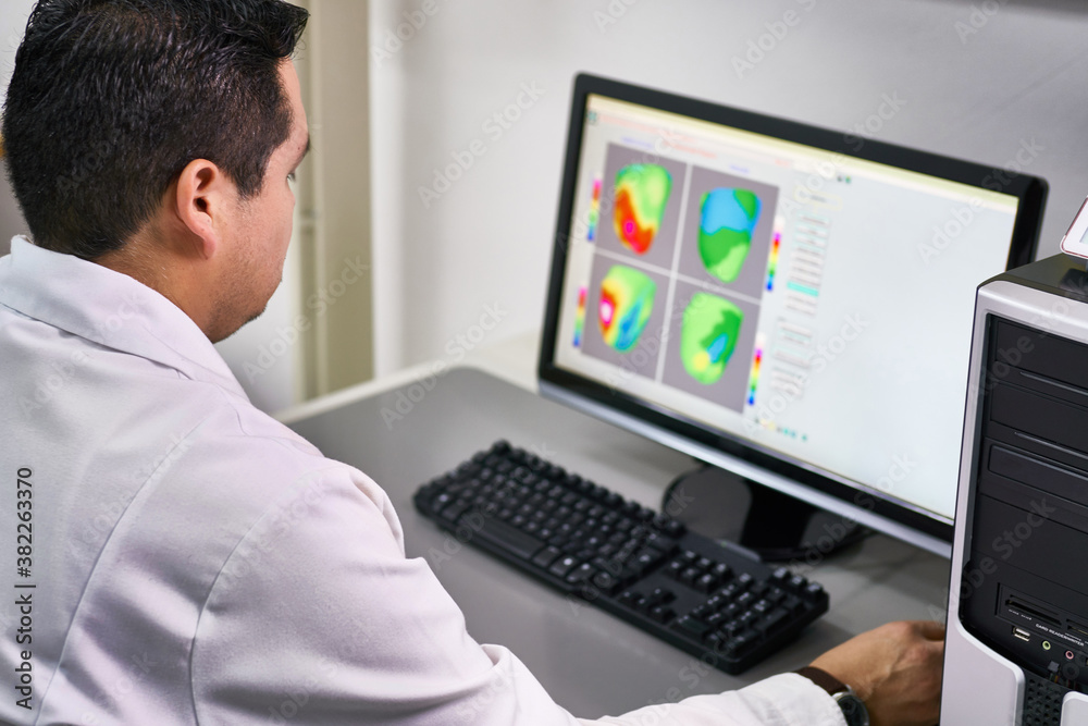 Scientist analyzing medical scanner imagery Scientist analyzing medical scanner imagery
