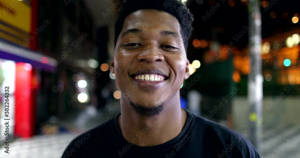 African man portrait smiling at night, looking at camera African man portrait smiling at night, looking at camera
