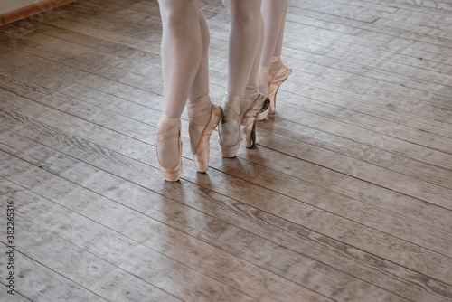 Crop ballerinas tiptoeing on floor
