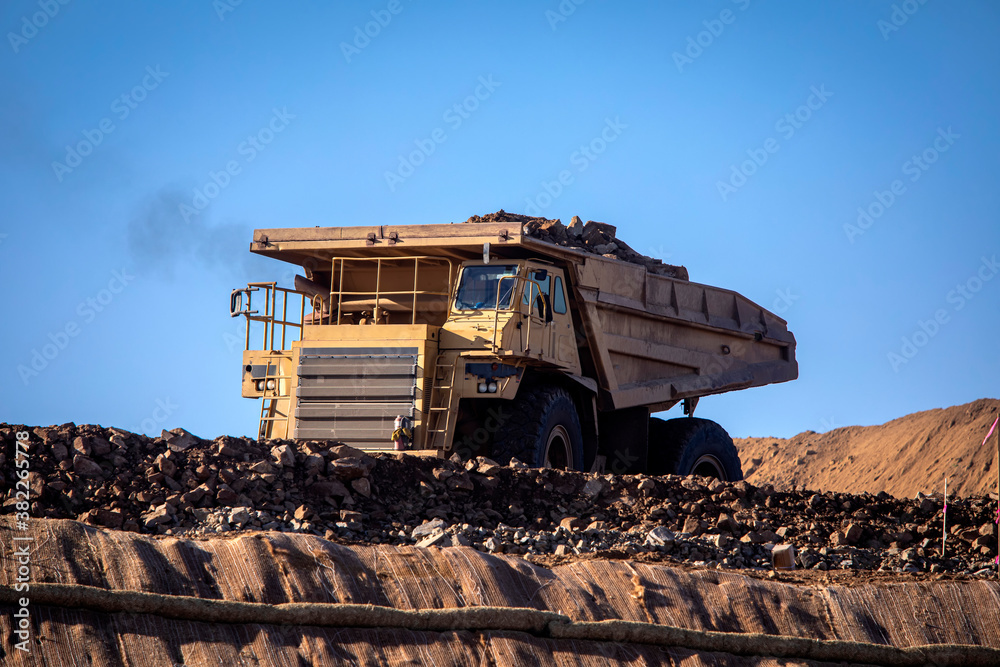 A very large haul dump truck at a construction site against a blue sky A very large haul dump truck at a construction site against a blue sky