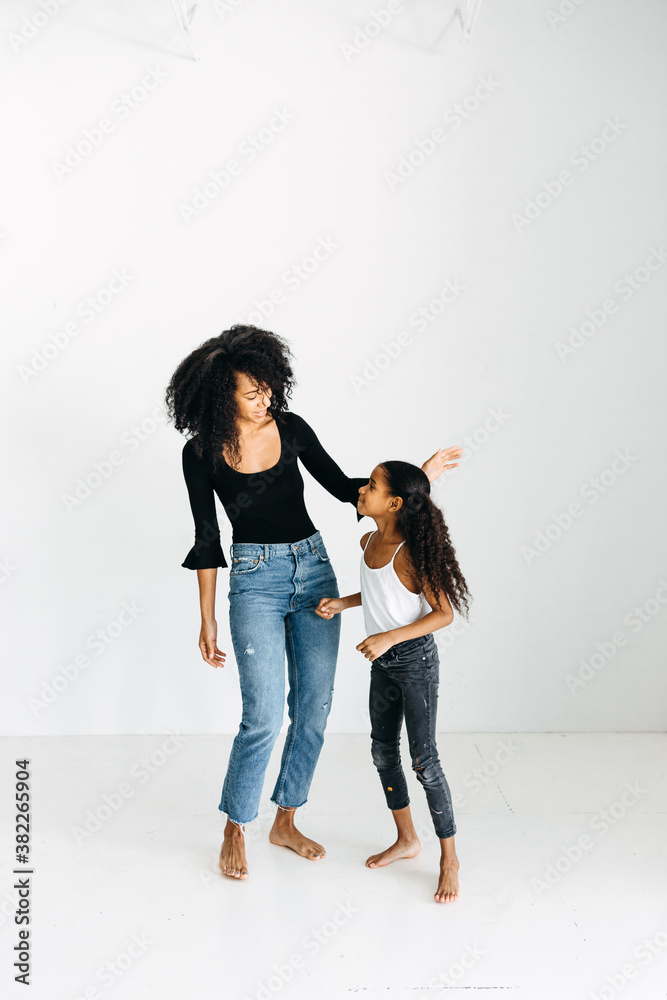 An African American mother & daughter playing & dancing. An African American mother & daughter playing & dancing.