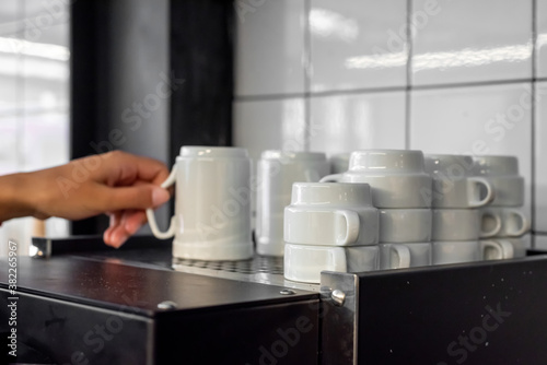 Woman taking a white coffee cup