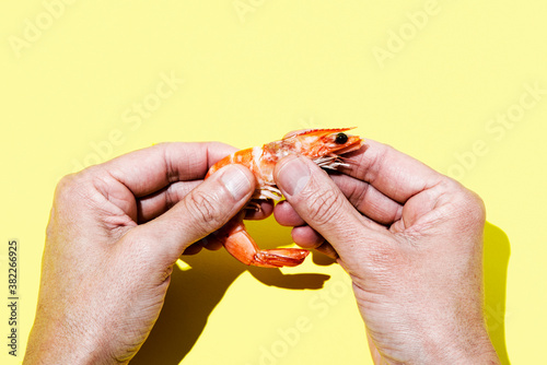 man peeling a prawn