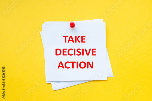 Word take decisive action on white sticker with yellow background