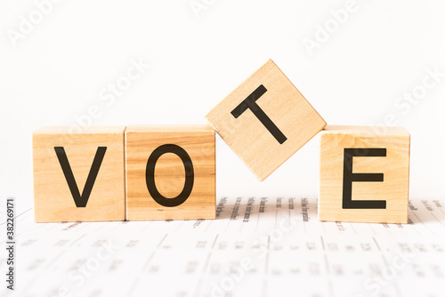 Word vote. Wooden small cubes with letters isolated on white background with copy space available.Business Concept image.