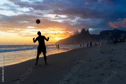 Man playing soccer in Ipanema Beach photo