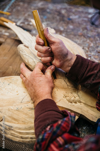 Woodworker at His workshop using chisel photo