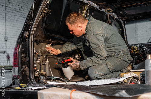 Technician cleaning insides of car photo