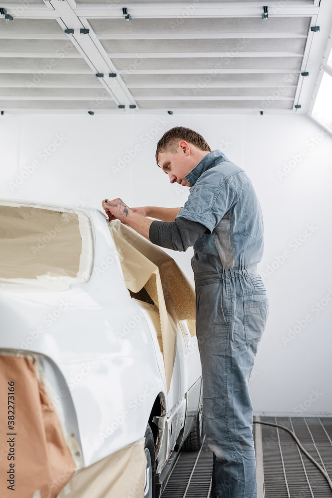 Mechanic attaching paper to vehicle window Mechanic attaching paper to vehicle window