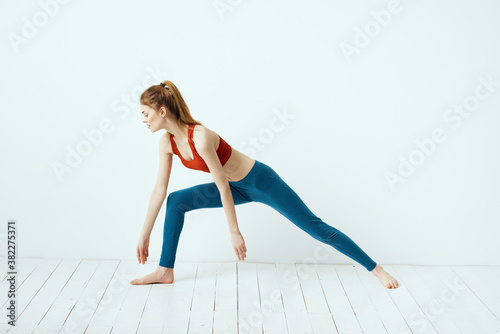 Sportive woman pose gymnastics balance exercise light background