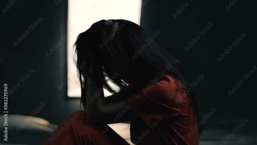 Broken heart woman is crying alone in the window. Silhouette of sad and ...