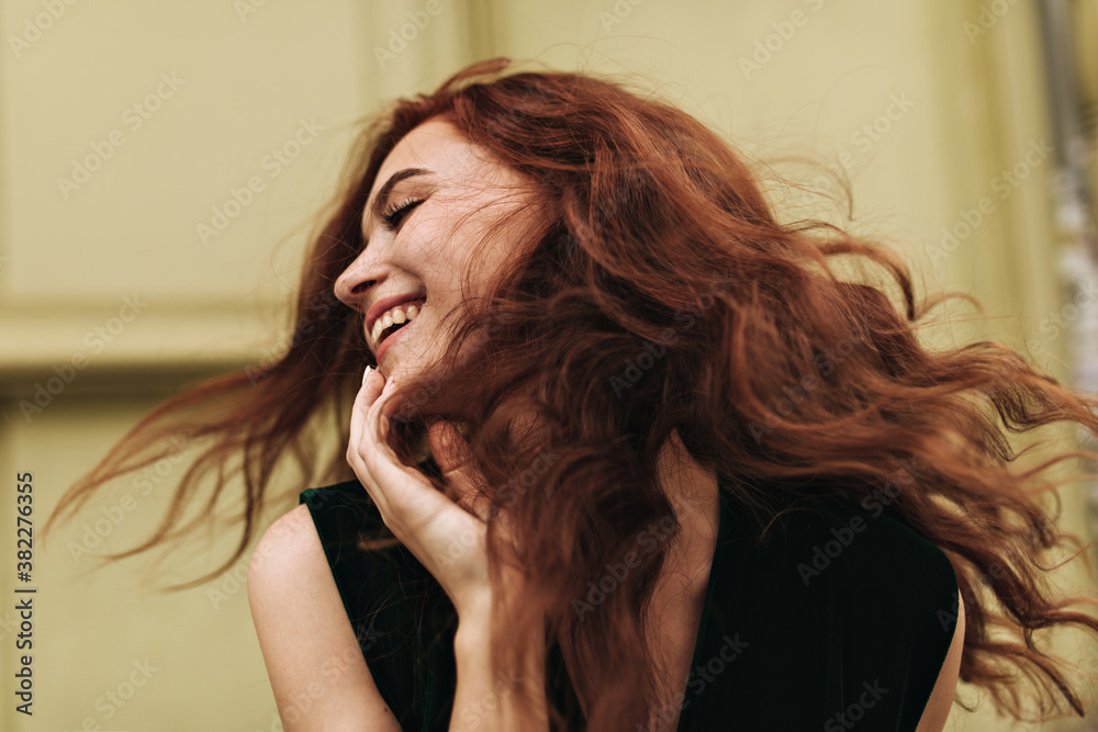 Fototapeta premium Curly woman posing outside and laughing