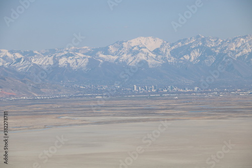 Downtown Salt Lake City and Wasatch Mountains from salt flats of Antelope Island, Utah