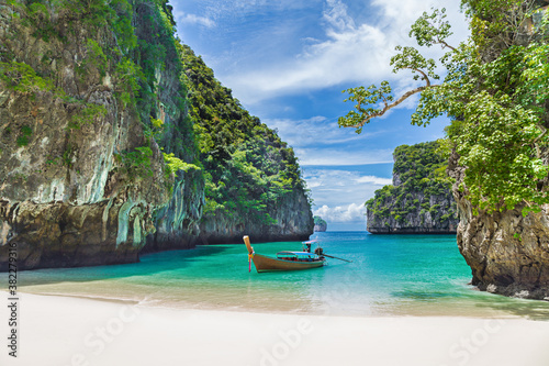 Thai traditional wooden longtail boat and beautiful beach in Thailand.