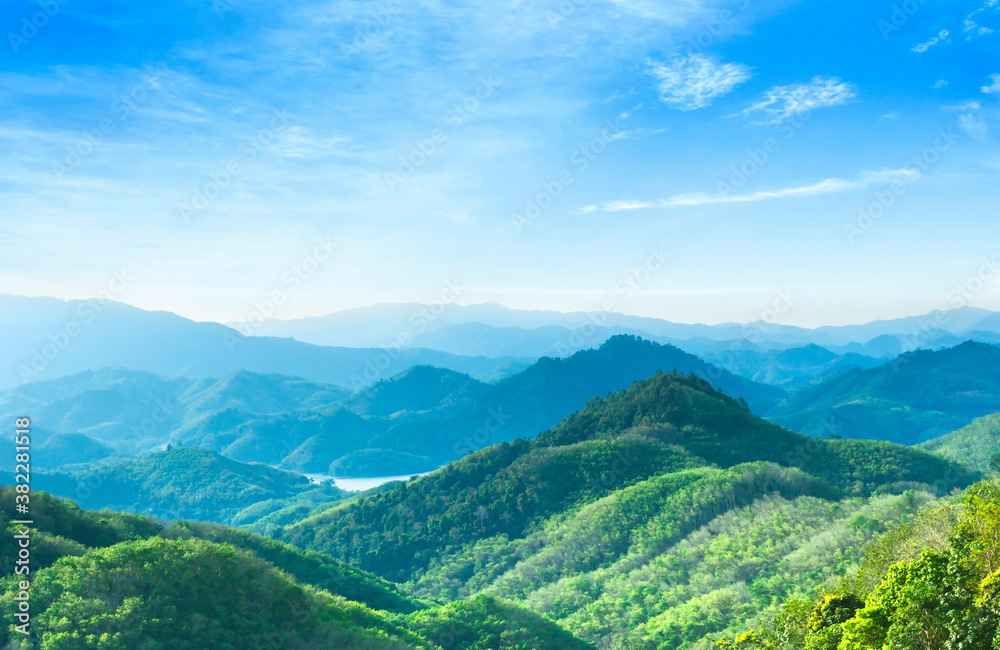 World Environment Day concept: Panoramic view of mountain range covered by forest with blue sky