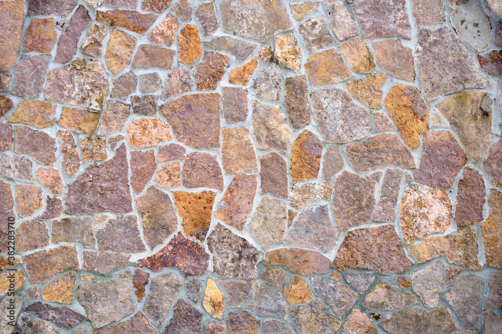 Stone wall with different pieces of tiles. Background Stone wall with different pieces of tiles. Background