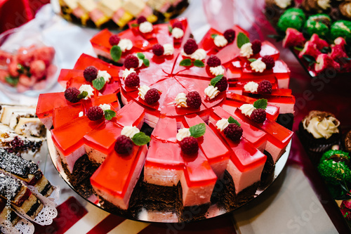 Sweet table. A plates with cakes. Table with sweets, buffet. Dessert table for a party goodies. Party reception, decorated delicious in restaurant. Candy bar.