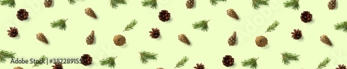 Pine cone Christmas background on green. Pine branches and cones. minimal creative cone arrangement pattern. flat lay, Modern christmas Background.