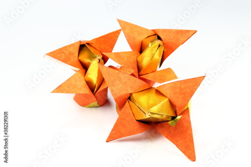 Traditional Chinese gold paper origami isolated on the white background. Using for pray in temple and pay respect in ancient ceremony or festive. Chinese culture and lifestyle concept. 