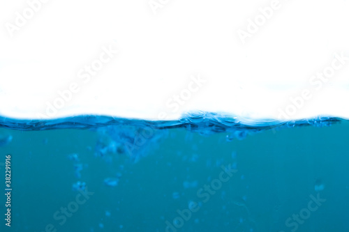 Water waves and light blue water droplets crystal clear on white background