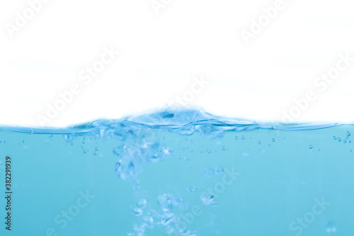 Water waves and light blue water droplets crystal clear on white background © watchara