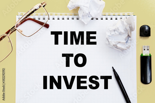 Wallpaper Mural glasses, pen and paper with text TIME TO INVEST. Business, financial concept. Torontodigital.ca