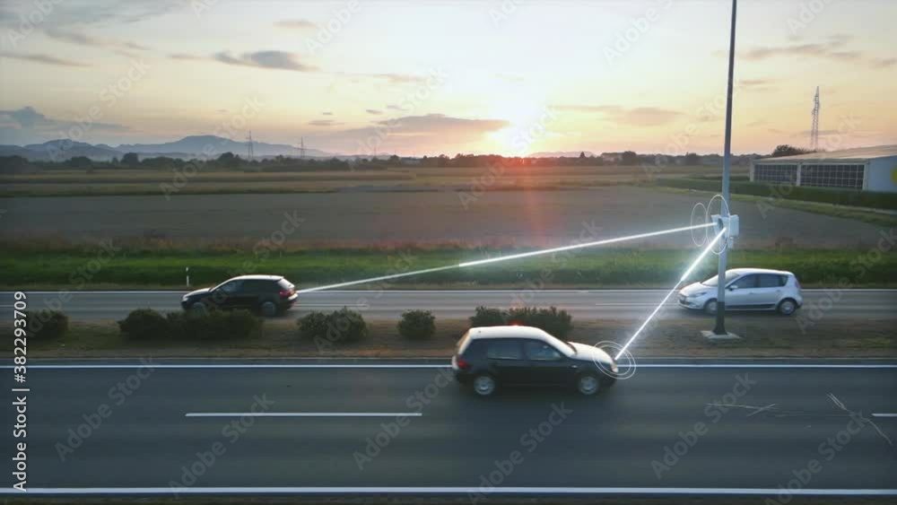 Traffic Control Camera System scans license plates of passing cars and analyzes the data during sunset. Street observation. Digital HUD animation overlay with light beams. Slow Motion.