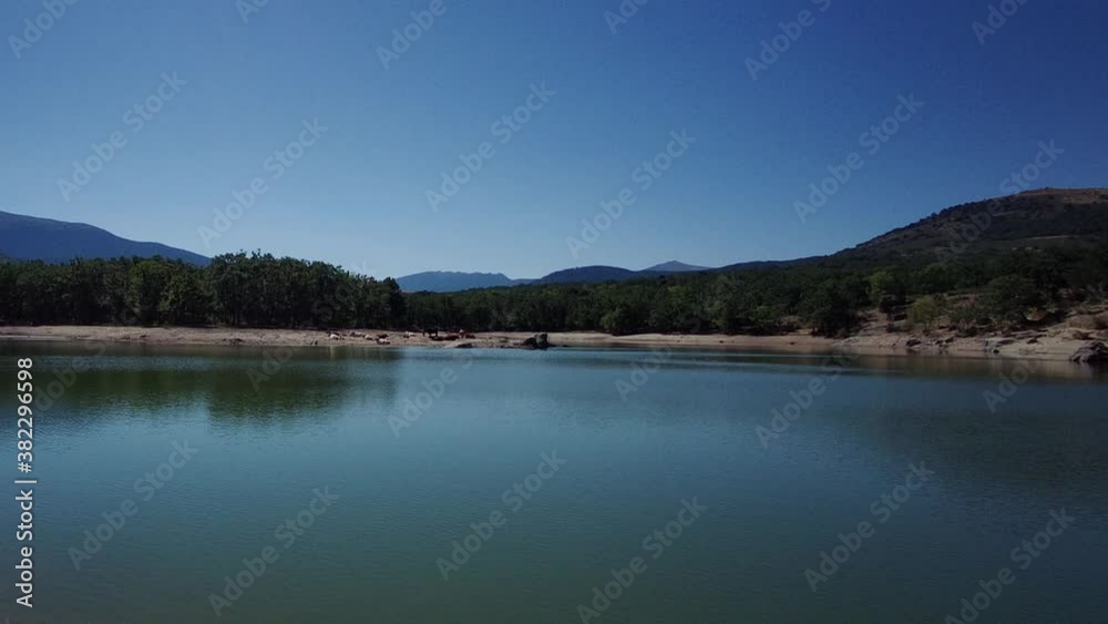 Beautiful view top of the water and mountains with green trees at background. Beautiful view top of the water and mountains with green trees at background.