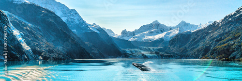 Alaska luxury cruise travel panoramic. Scenery landscape panorama with humpback whale composite breaching out of waters on glacier bay background.