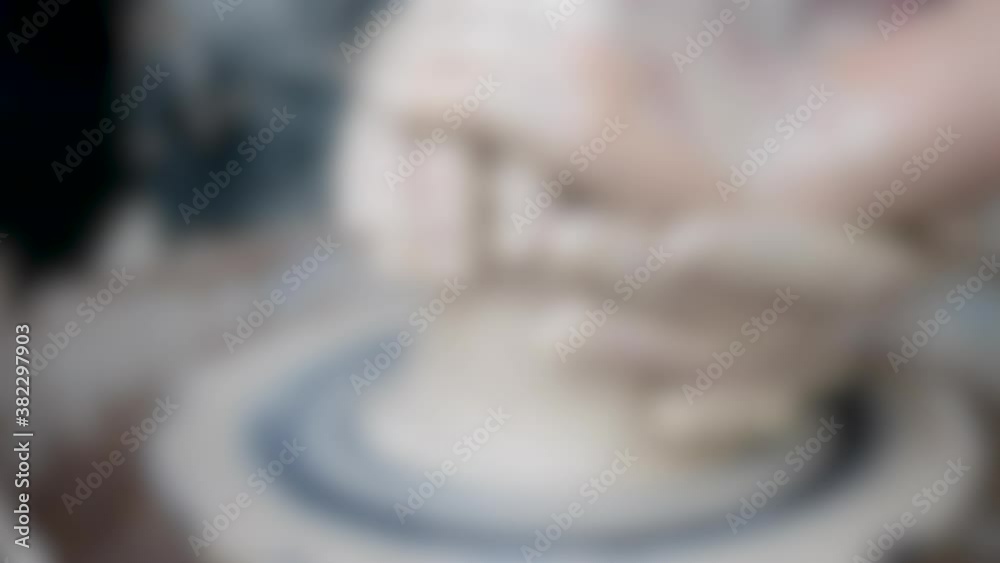 Blurred background. Workshop Molding of clay on a potter's wheel Blurred background. Workshop Molding of clay on a potter's wheel