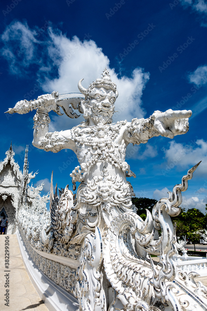 Fototapeta premium Place of worship, Wat Rong Khun also known as the white temple, located in Chiang Rai Province, Thailand. A unique style Buddhist temple with the bridge of “the cycle of rebirth”